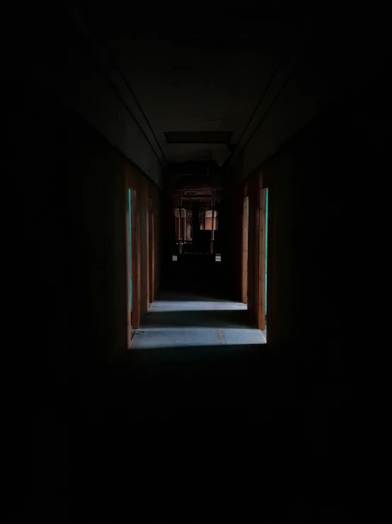 a dark hallway is lit by lights from lamps