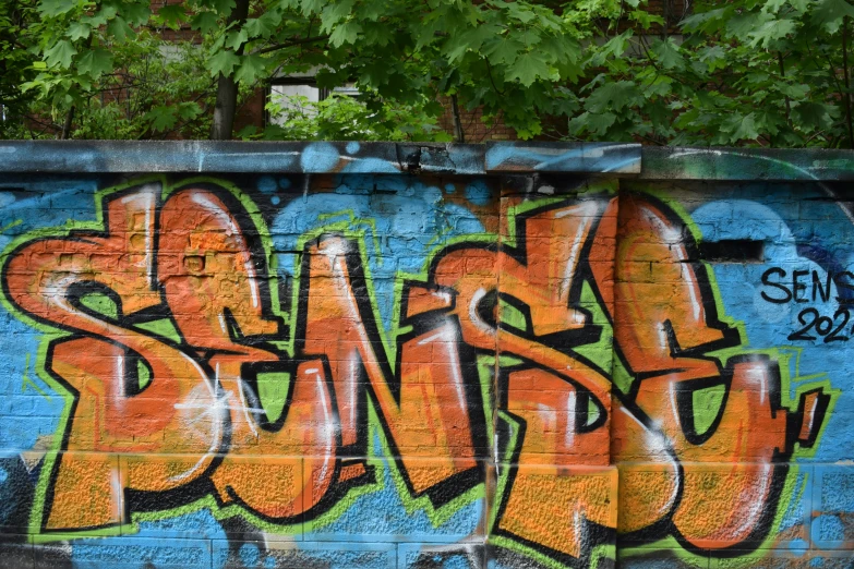 graffiti on the side of an old brick wall