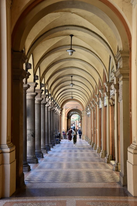 people walking through the covered walkways at a shopping center