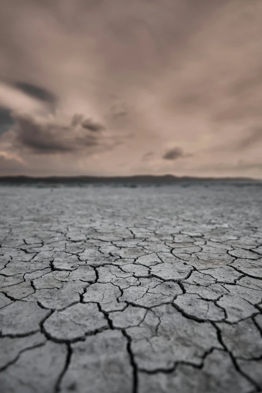 a barren area with rocks under cloudy skies