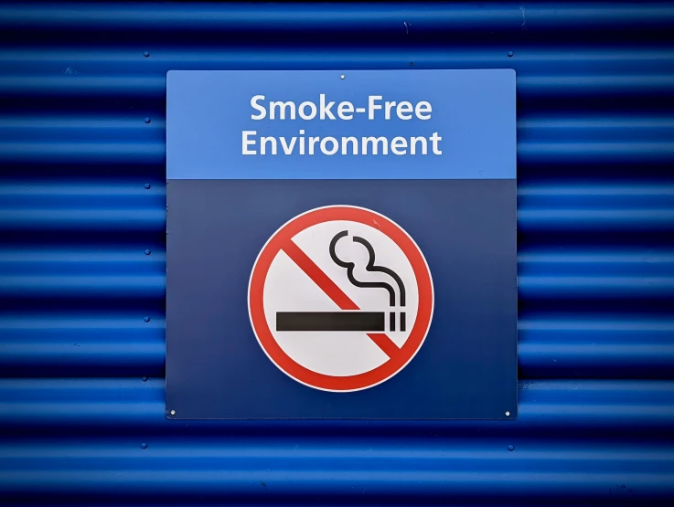 a no smoking sign with words smoke free environment