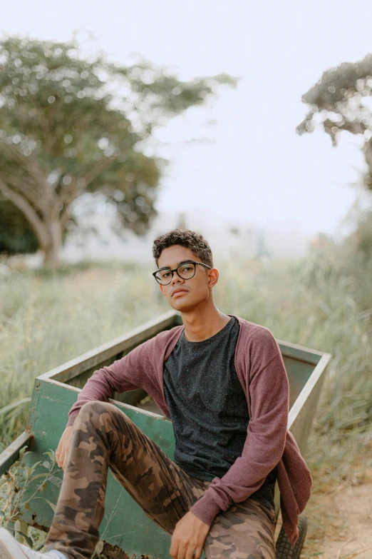 a man sitting in a small boat on the grass