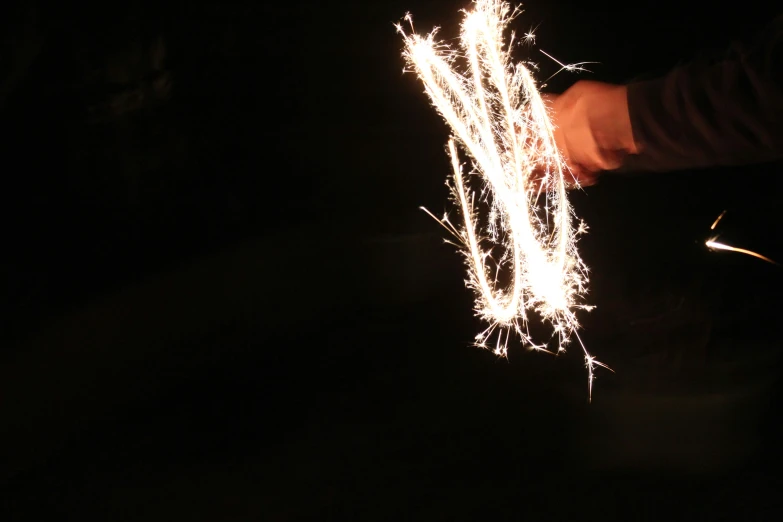 a sparkler being used to light a fireer