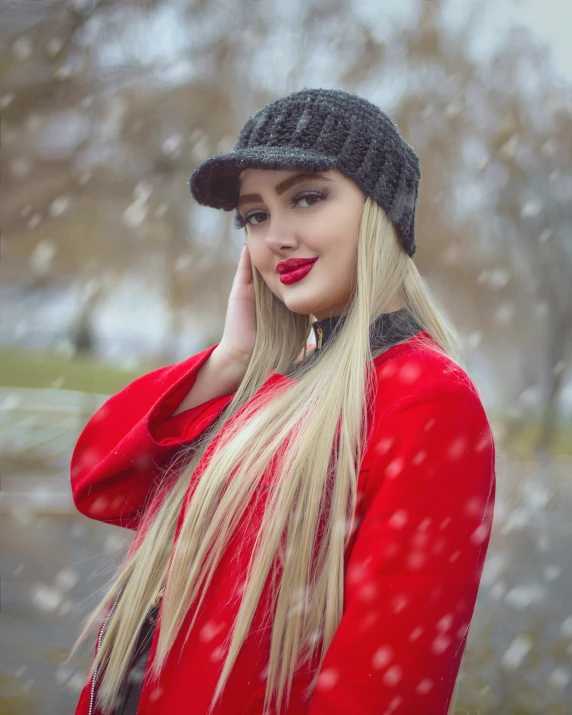 a woman wearing red and black clothing while she's posing with her hair in the wind