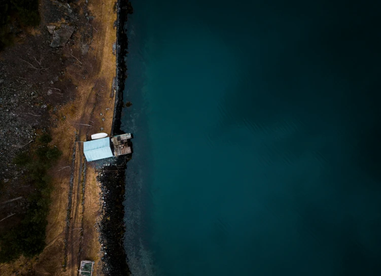 an aerial view of a house in the water