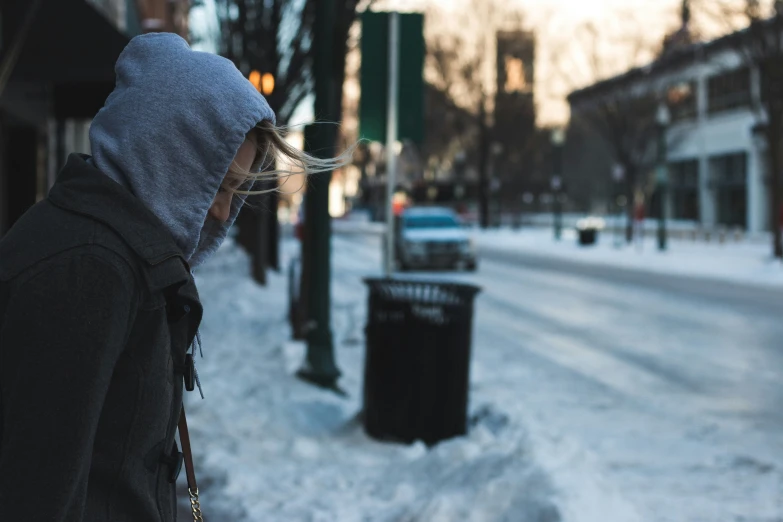 a person walking down a snowy city street