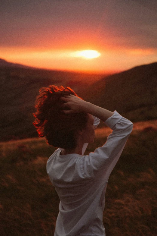 a person standing in the sunset looking off into the distance