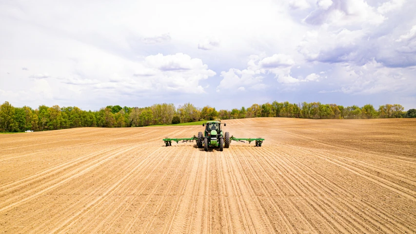 the tractor is driving in the large field