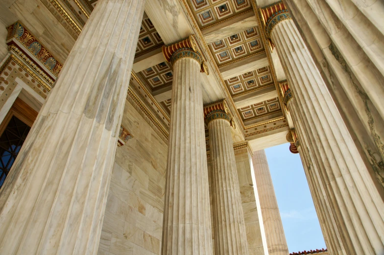 a number of tall columns inside of a building