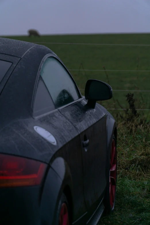 a car parked in front of the camera on a field