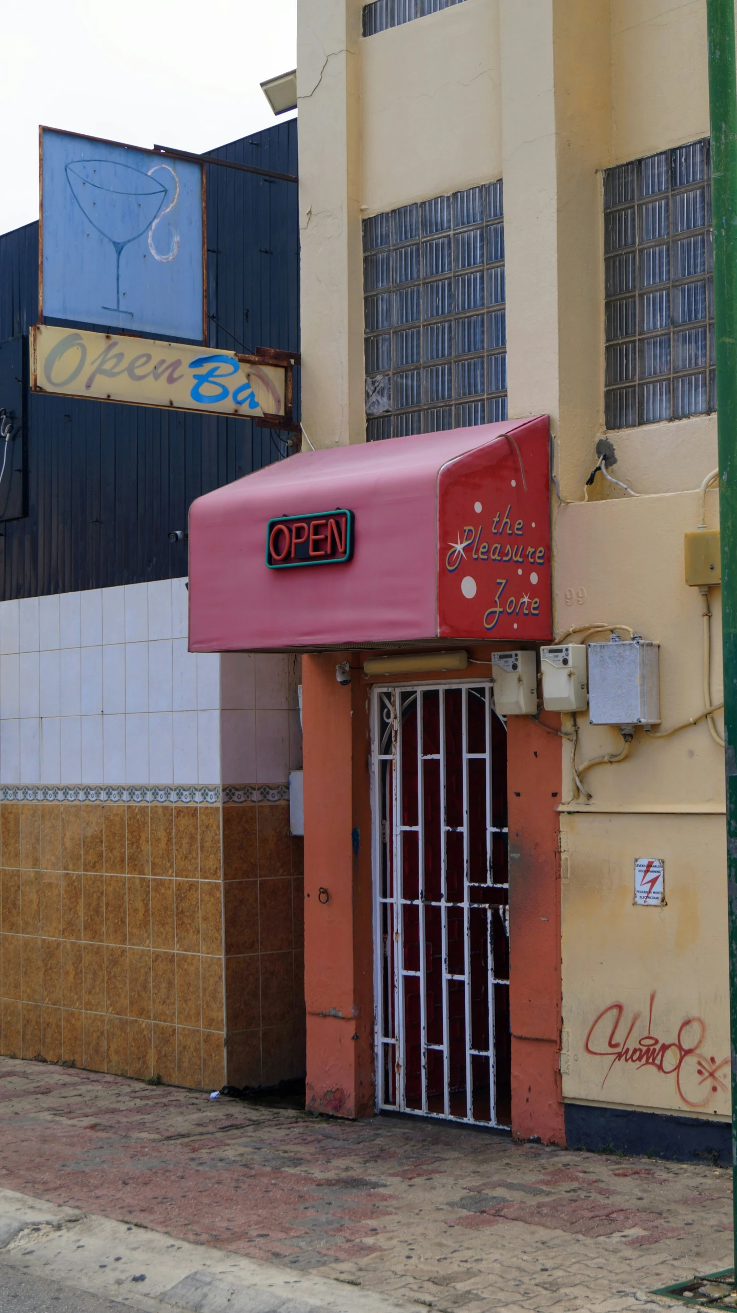 a storefront with some graffiti on it on the side of a building