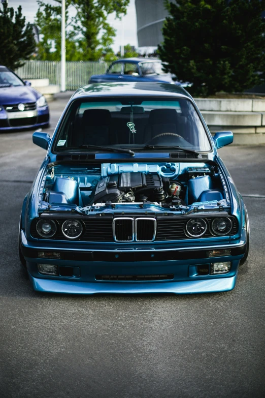 blue bmw on a parking lot with other cars