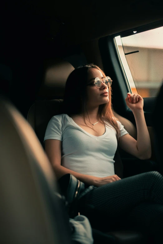 a girl in a car smoking a cigarette