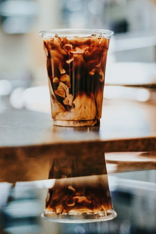 a cup of liquid is shown on a table