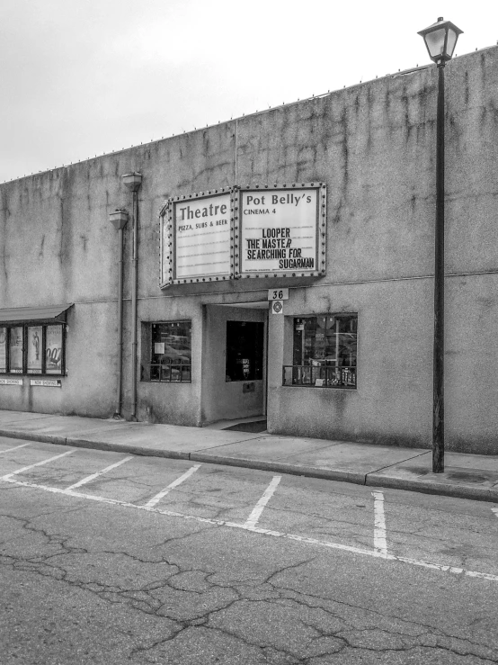 an old theater is up against a large concrete building