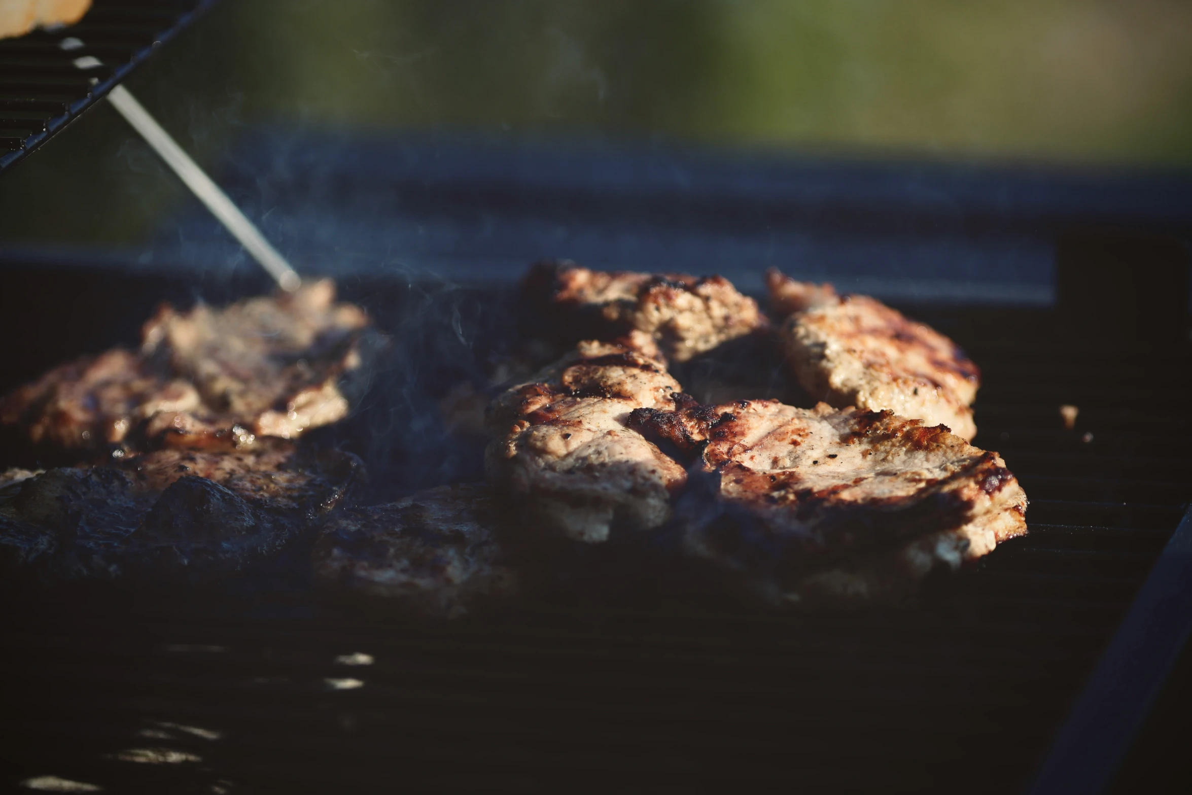 some food is cooking on the grill outdoors