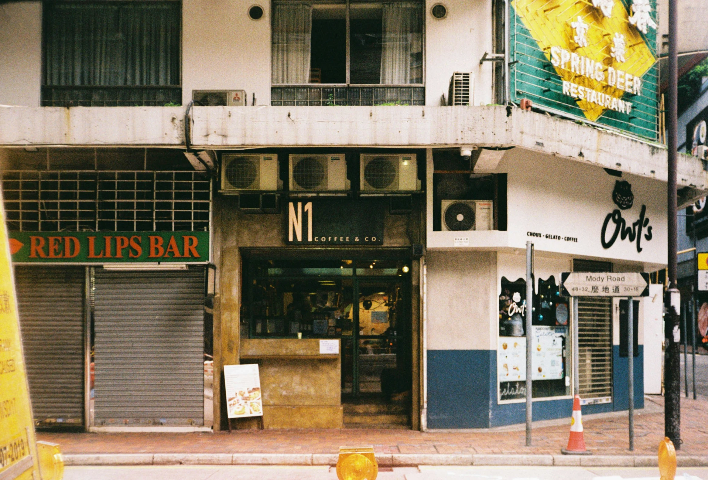 a building is next to a street with a sign on the outside