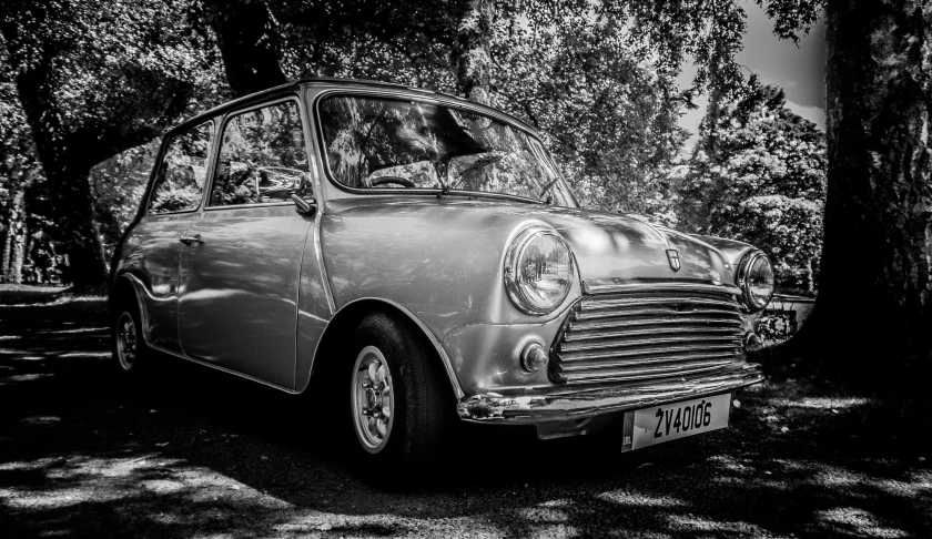 an old fashioned car parked near some trees