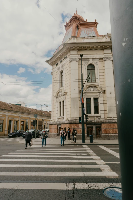 an image of people crossing the street in a city