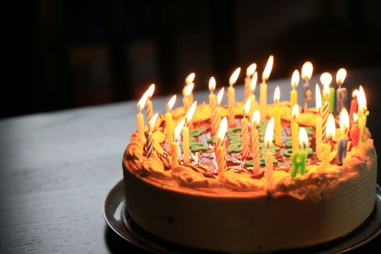 a birthday cake with burning candles on it