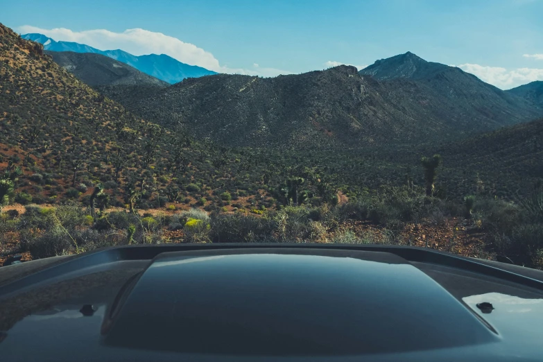 a view from the hood of a car of a mountain range