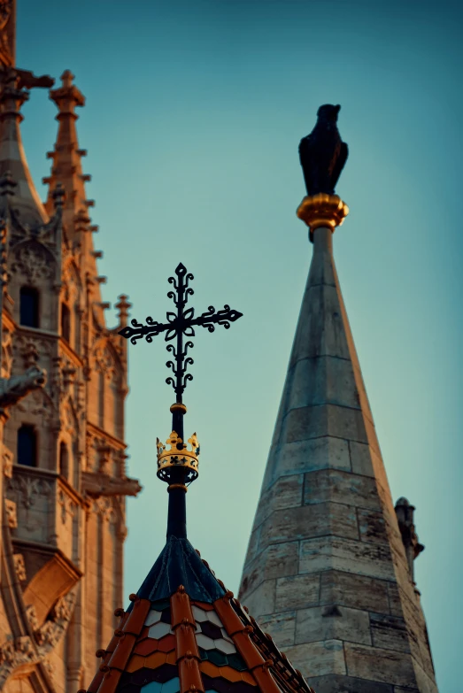 a view of a cross and steeple on top of a building