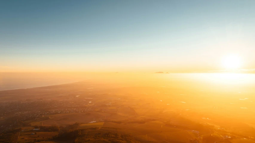 a sunset view from an airplane flying over the city