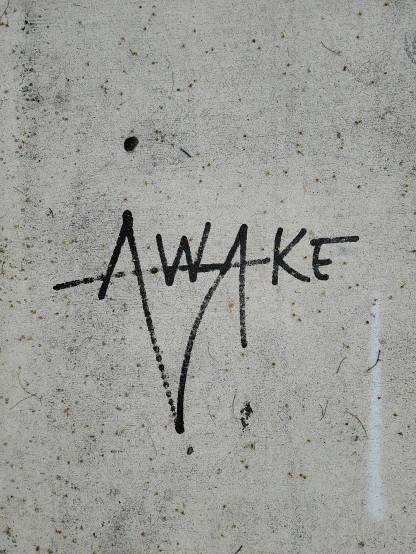 the words awake written on a white surface