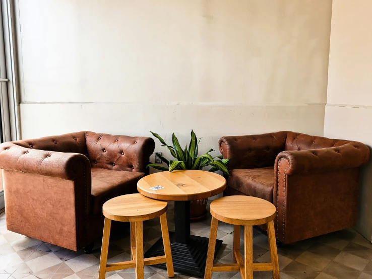 three chairs and a table set up in a living room