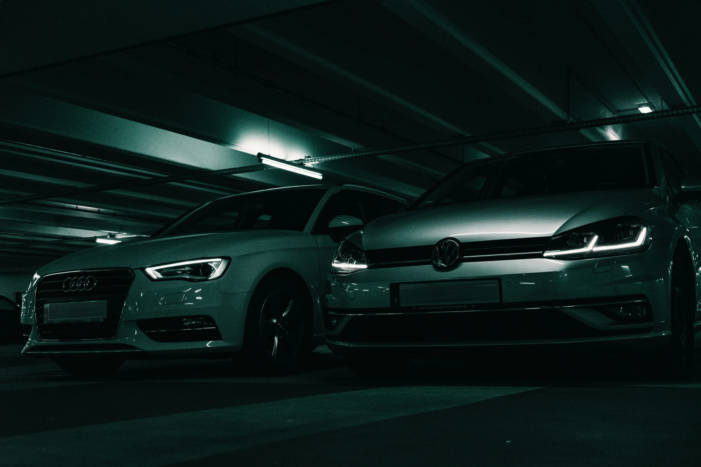 a green car that is in the middle of a garage