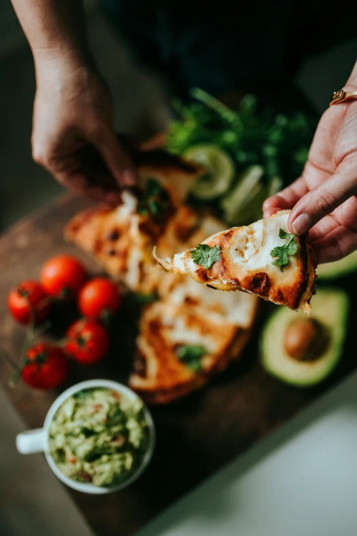 the person has slices of pizza on a  board