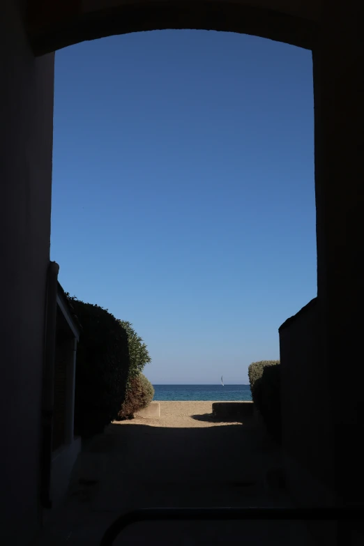 an image of an archway leading to the beach