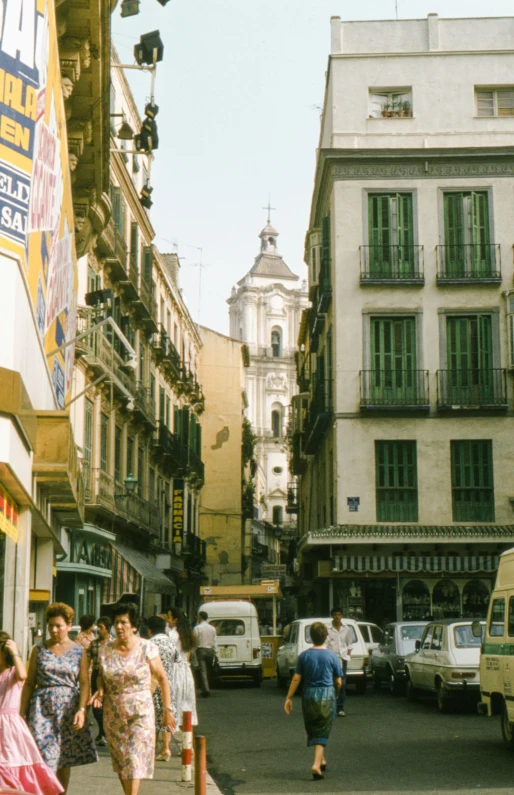 there are people walking in the busy streets