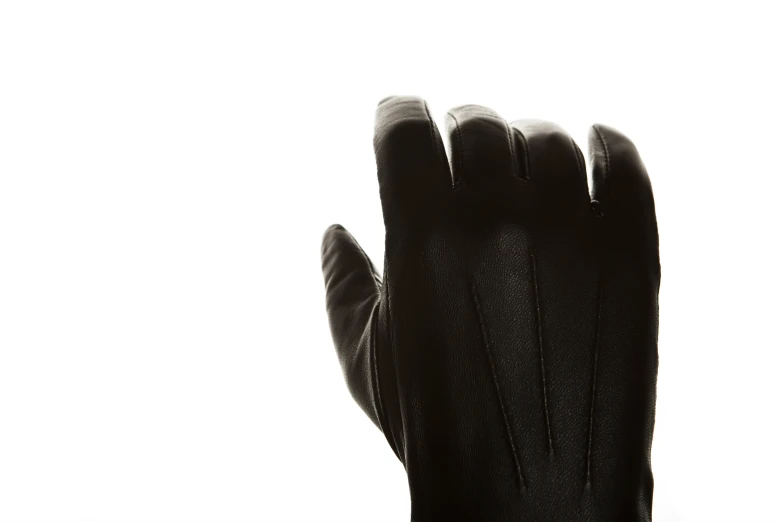black gloves sitting on top of a white background