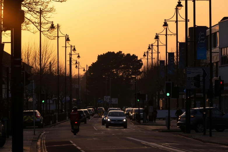 a street with cars and some trees in the background