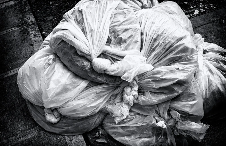 a black and white po of an overloaded garbage bag