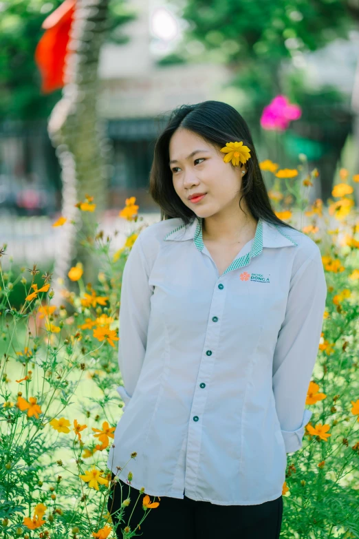 a woman posing for a picture with flowers in front of her