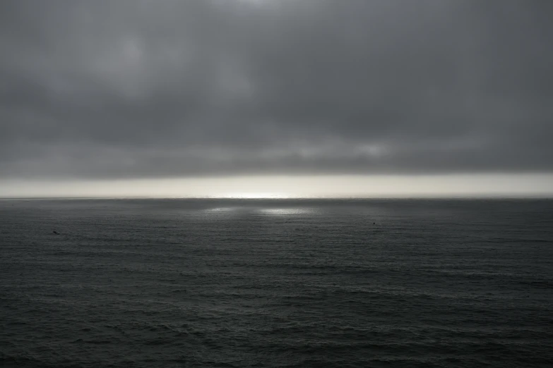 a ship is out on the open sea under grey skies