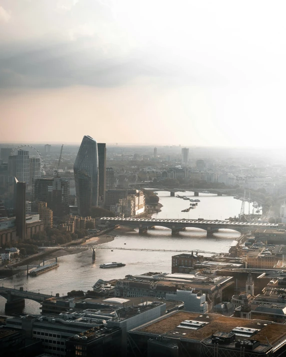 an aerial view of london, showing tower cranes and the river thames