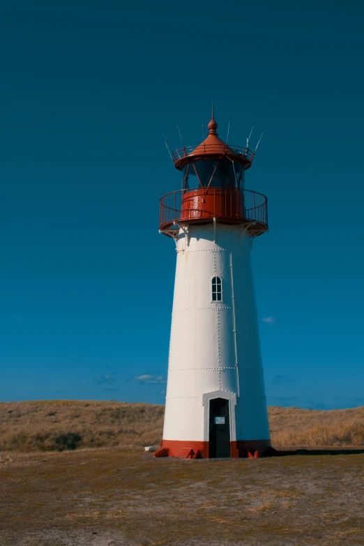 an old looking light house in a large open field