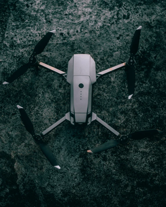 a white remote controlled flying airplane on the ground