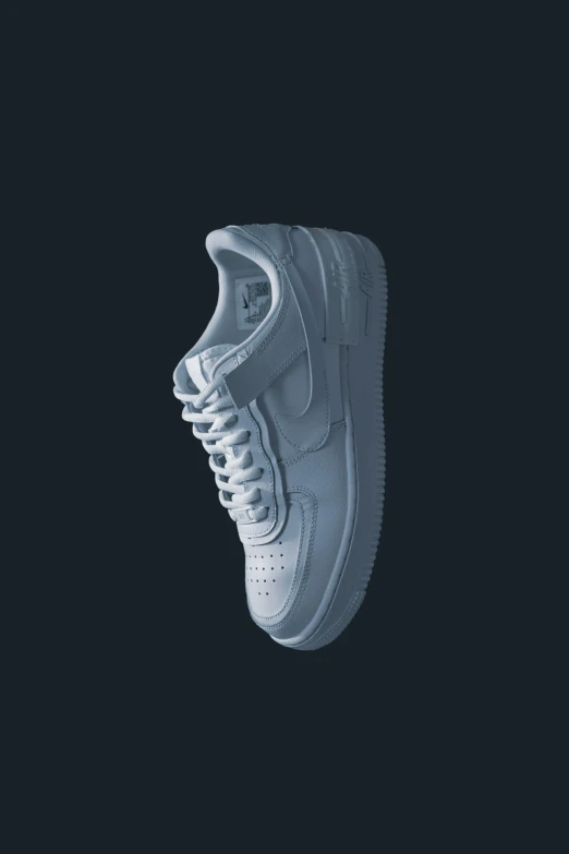 a white sneakers is against a black background
