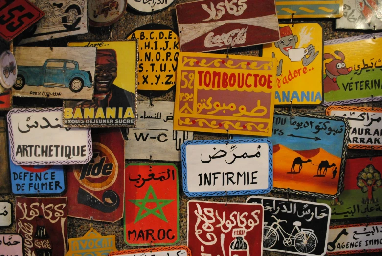 many different street signs are seen on a wall