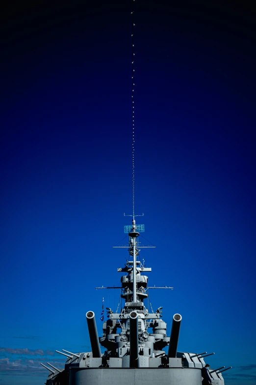 an airplane is flying above a large ship