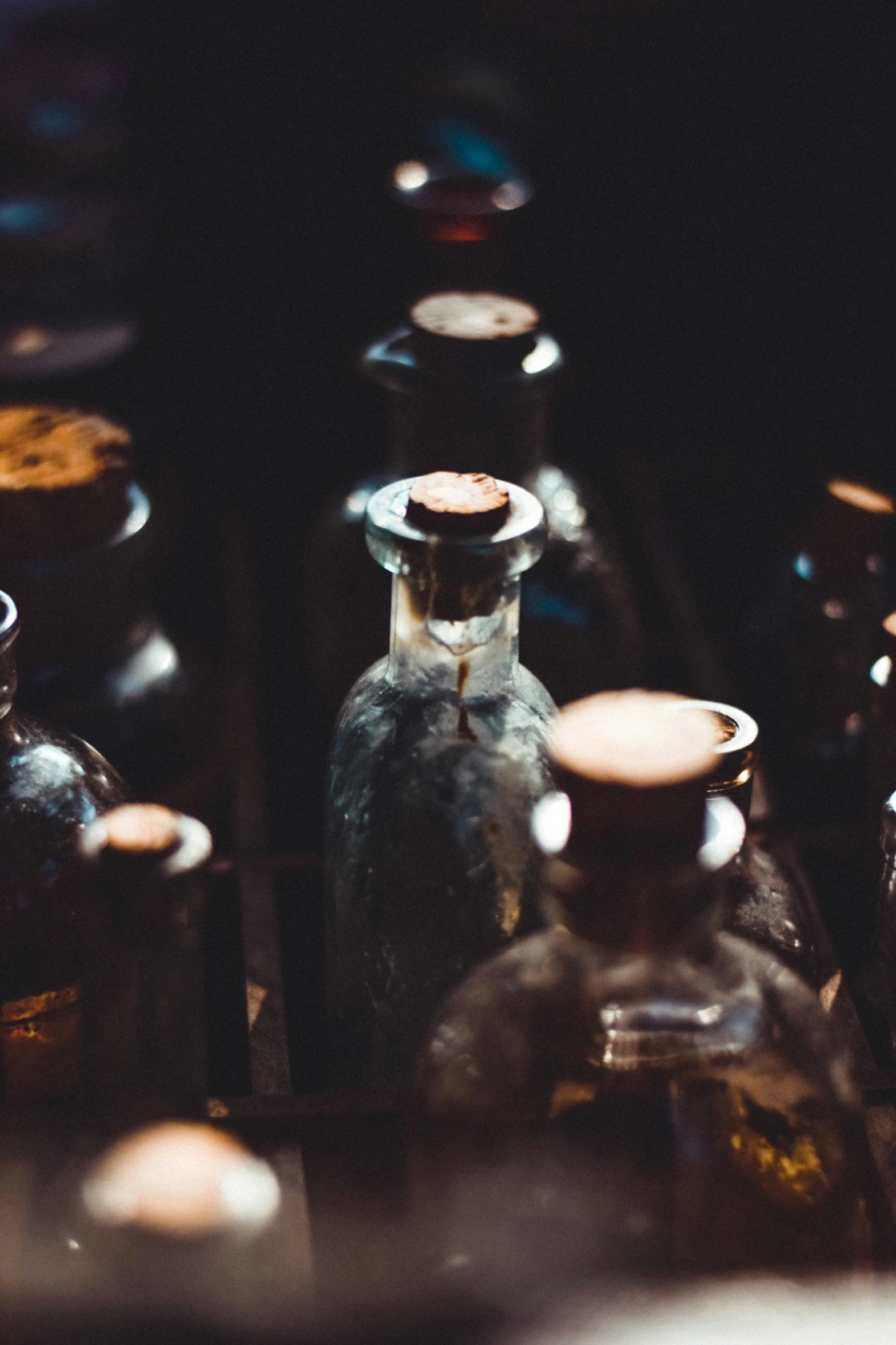 many small bottles and containers all on the table