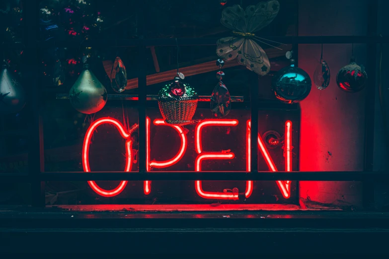 a neon sign is lit up in the dark