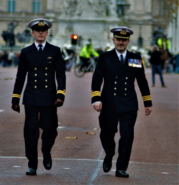 two pilots in uniform walking on a street