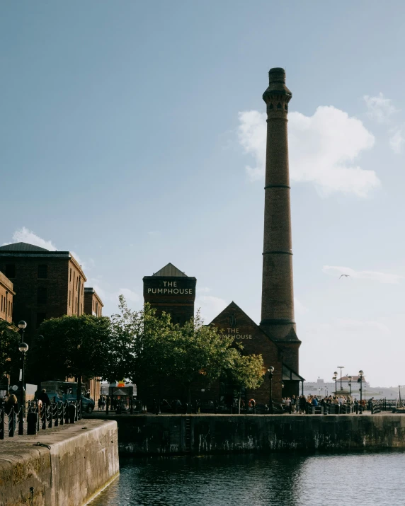 a tall pipe sticking out from the side of a river