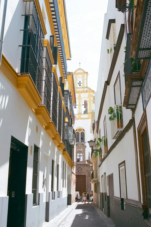 narrow street with many buildings with balconies on top