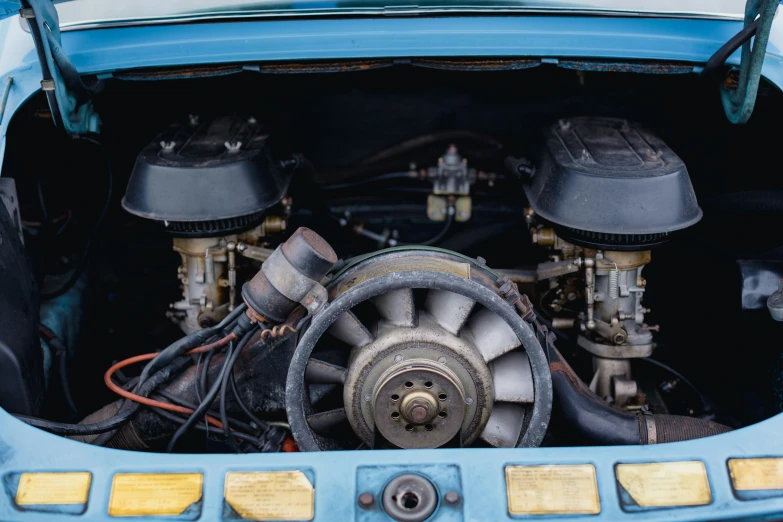an engine and its gear are visible from under the hood